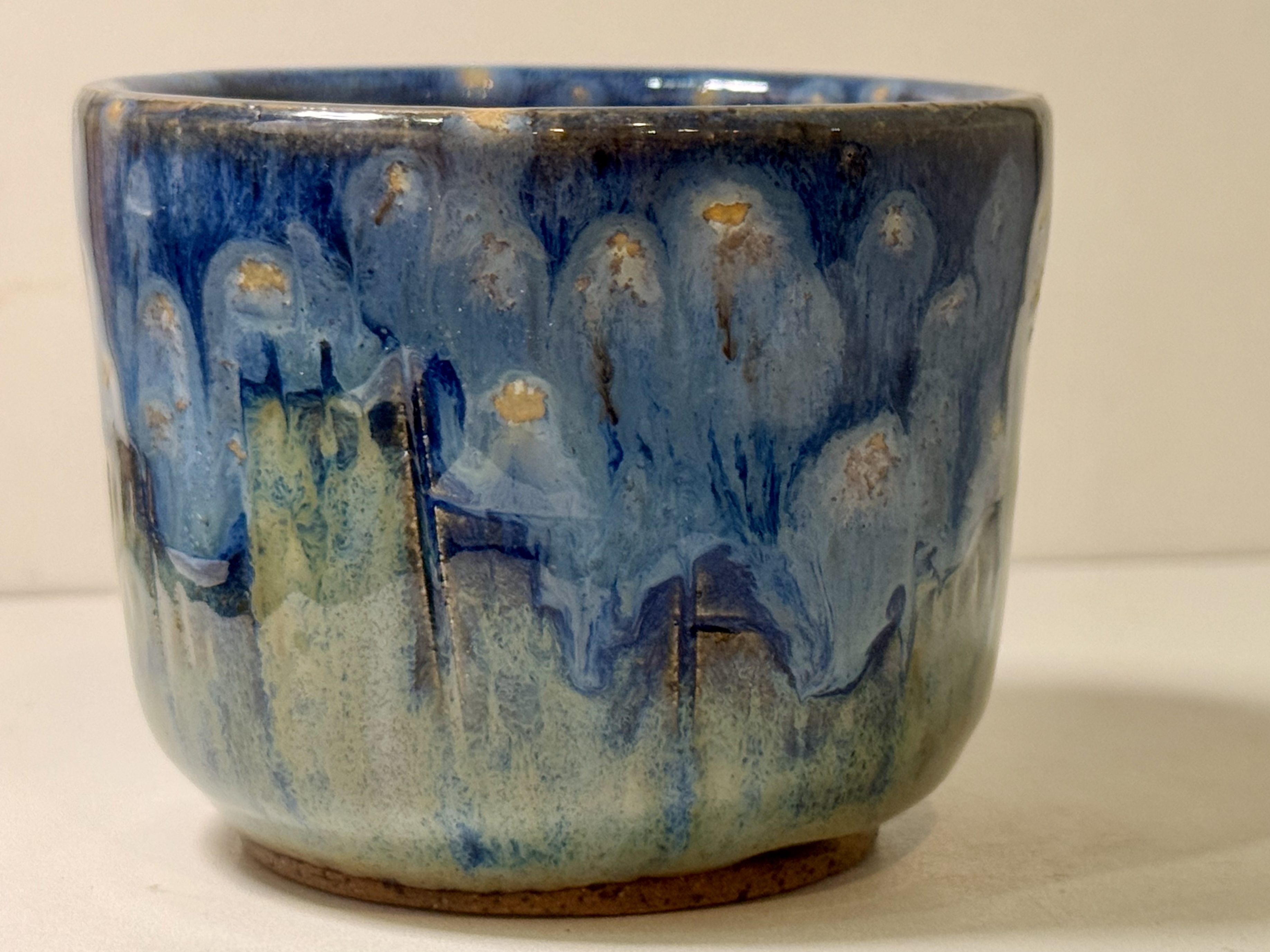 Blue glaze over the carved houses.