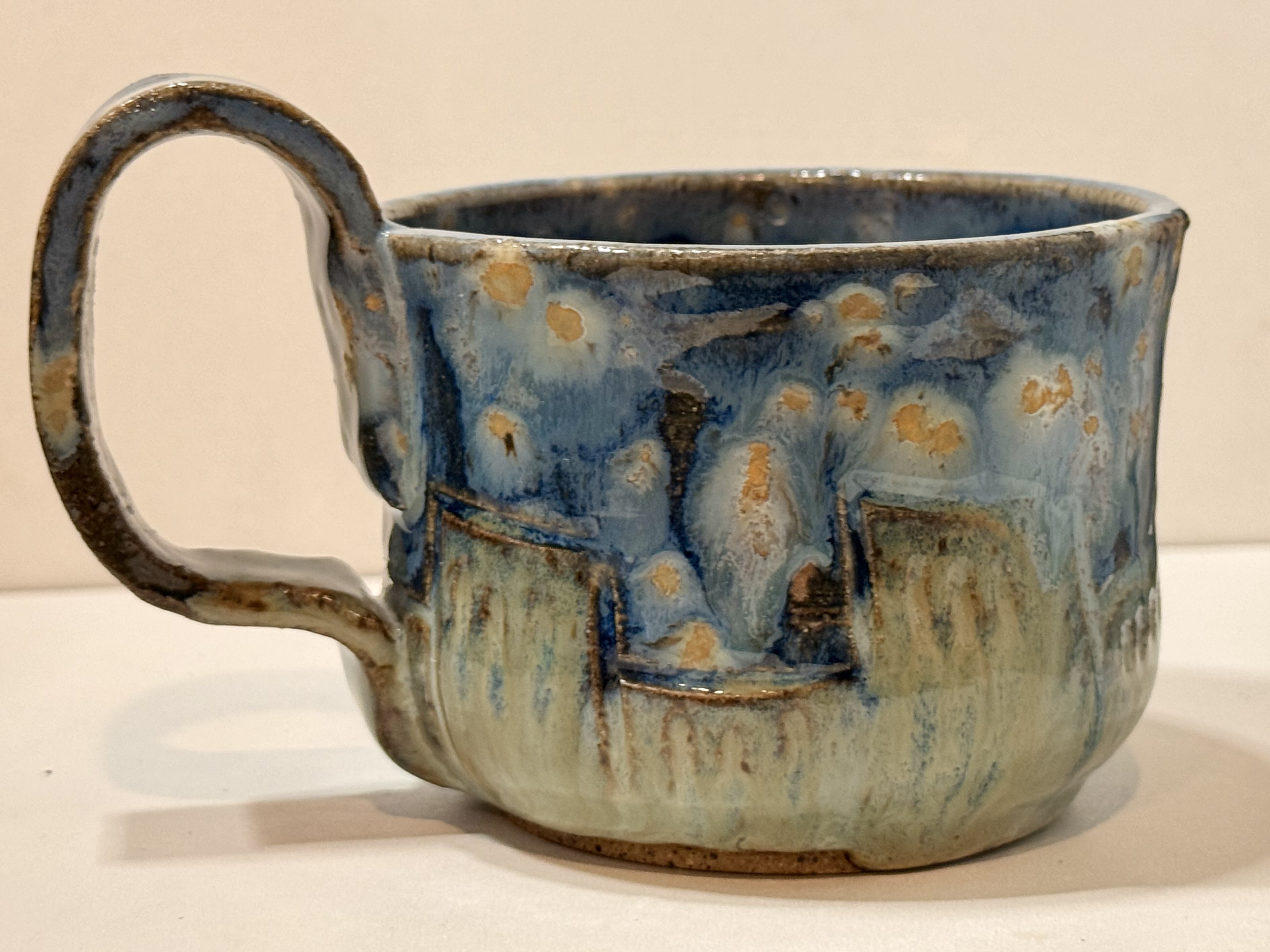 The finished blue mug and its handle.