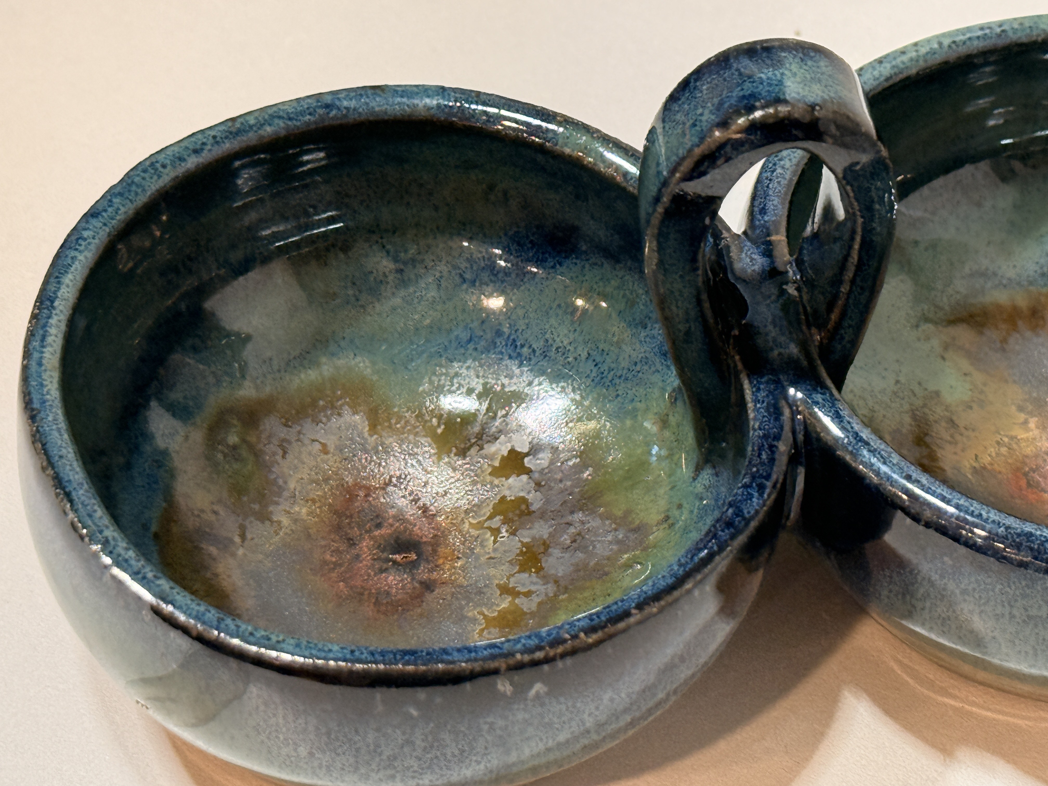 A close view of the glaze inside the joined bowls.