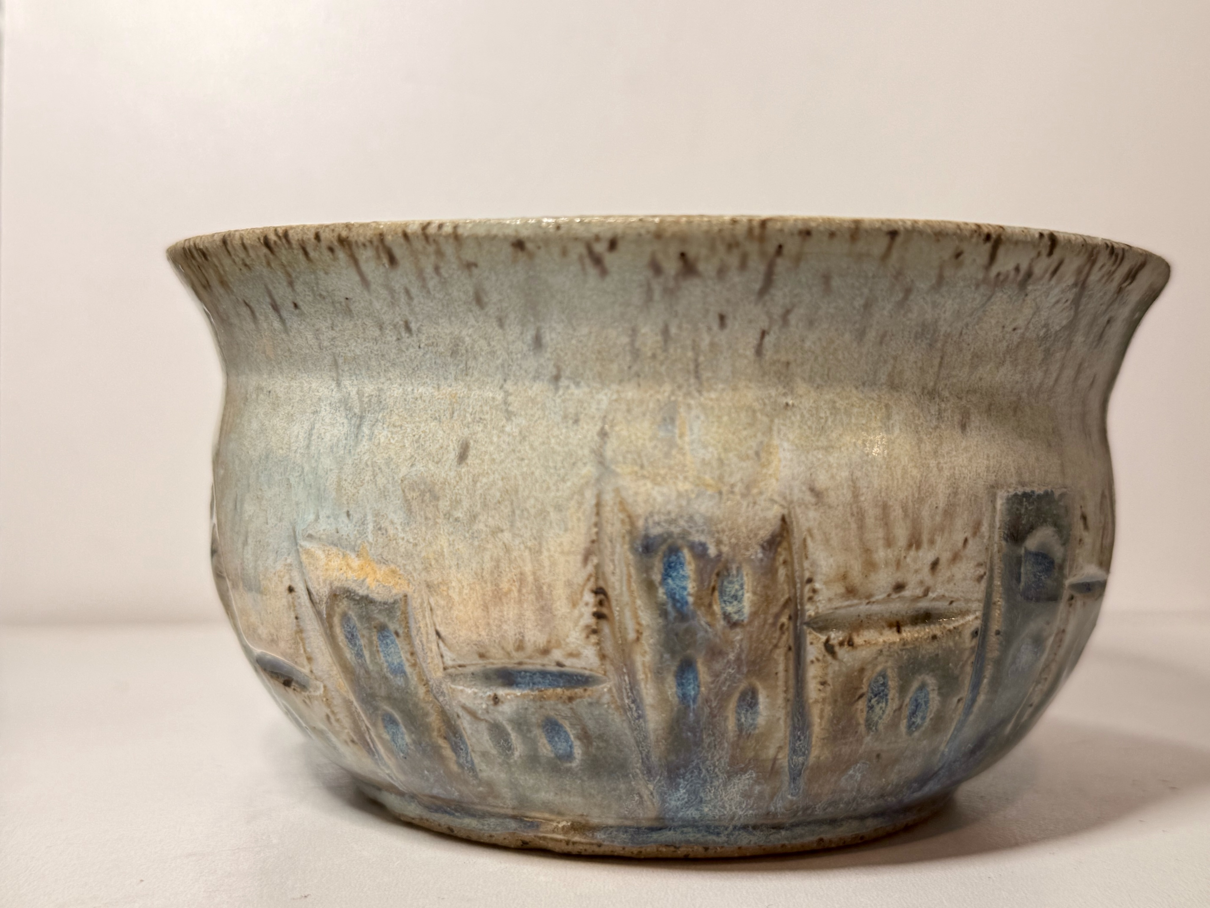 A bowl decorated with little houses.
