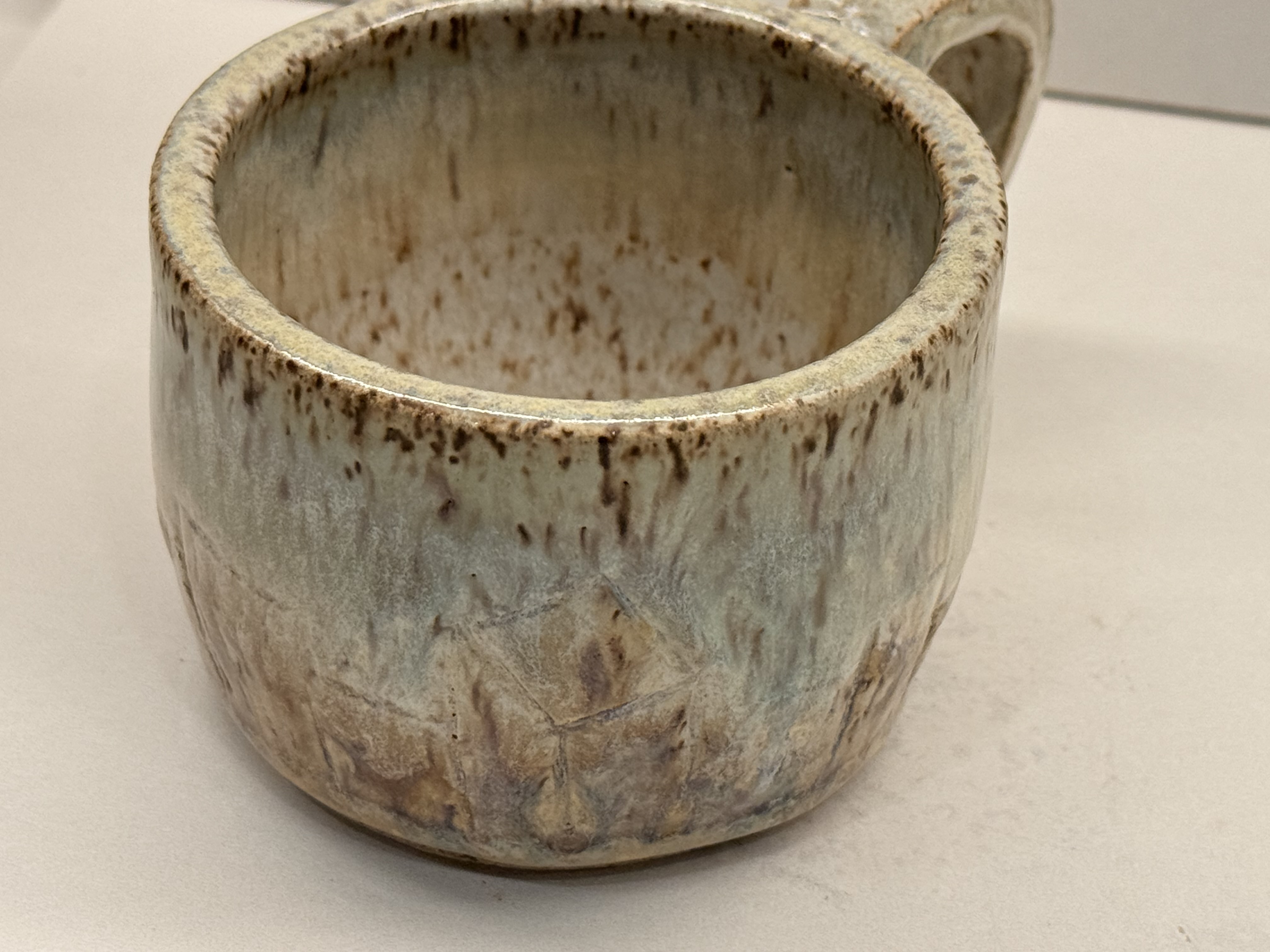 The inside and rim of the pale mug.